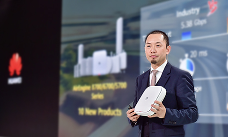 A head and torso shot of Qiu Heng, Chief Marketing Officer for Huawei Enterprise, holding an AirEngine Wi-Fi 6 AP