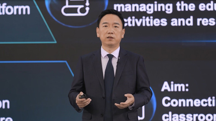Huawei's Xu Jun and Pan Yong each pressing a VFX button to virtually launch HUAWEI IdeaHub Board, key to smart education